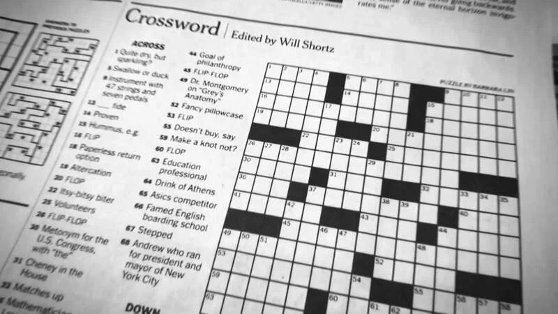 A jar of sauerkraut, a popular sauer condiment, with the New York Times crossword puzzle in the background.